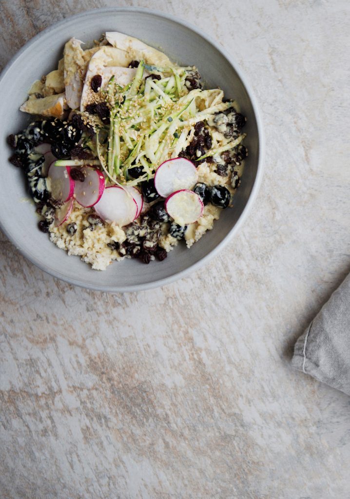 Millet, chicken, olives, grapes, radish bowl with a tahini sauce